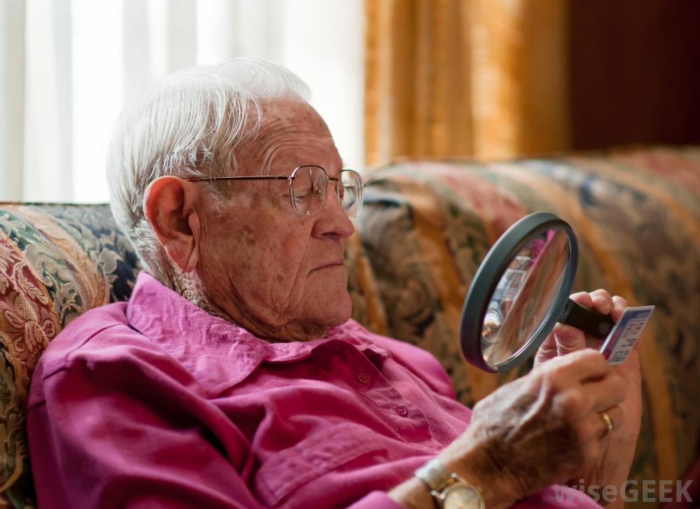 Service user using a magnifying glass to see a card