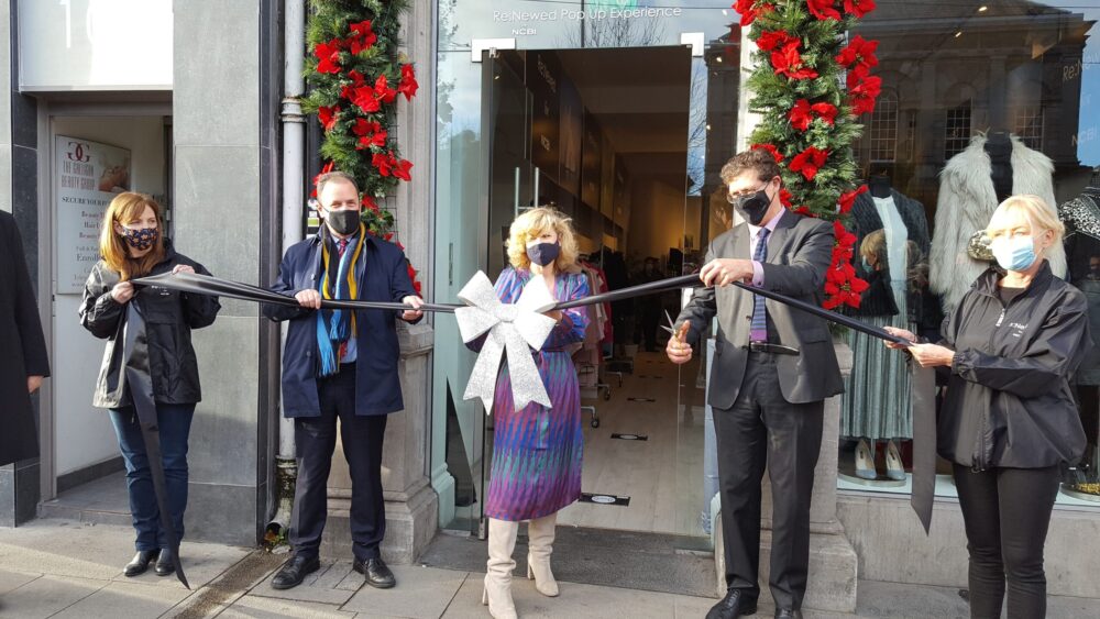 Photo of 5 people cutting the ribbon in front of the pop-up shop on Grafton street