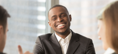 Man smiling as he speaks to employers