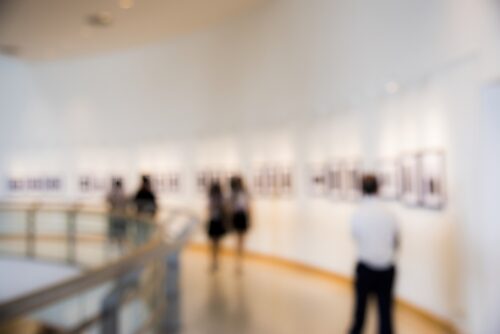 blurred image of people enjoying an art exhibition