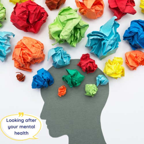 A dark silhouette of a person's head is in the middle of the image. From the top of the person's head is a number of coloured piece of paper crumpled up. The pieces of paper symbolises a person's thoughts coming from their mind. There is text on the bottom left of the image which reads Looking after your mental health.