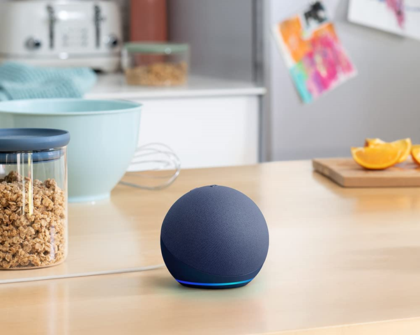 Spherical Amazon Echo Dot 5th Generation in Charcoal on a kitchen table