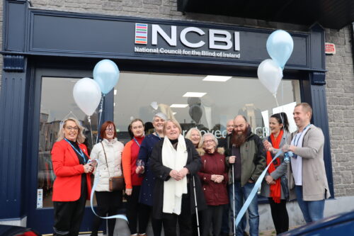A group standing outside the Vision Ireland Portarlington store. Among the group are service users, including Marian Murray who was the VIP guest to cut the ribbon to open the store.