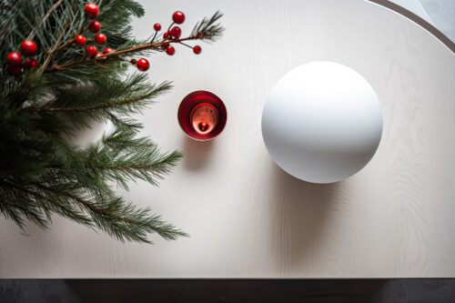 A Christmas tree next to a smart speaker on a table