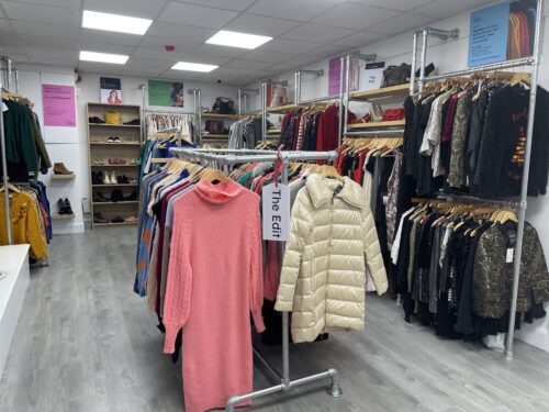 The interior of the Vision Ireland Midleton fashion shop which has rails of clothing in the middle of the shop and on the wall to the right.