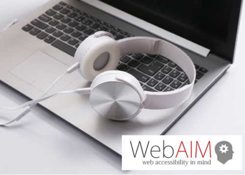 Headphones resting on a laptop next to the WebAIM logo